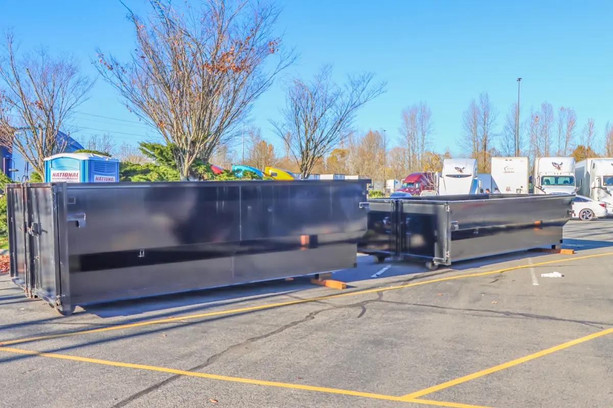 Professional dumpster rental service with roll-off container on residential driveway in Vinings